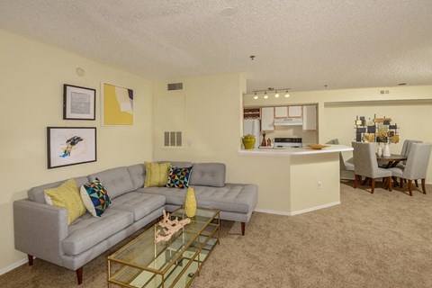 a living room with a couch and a glass table